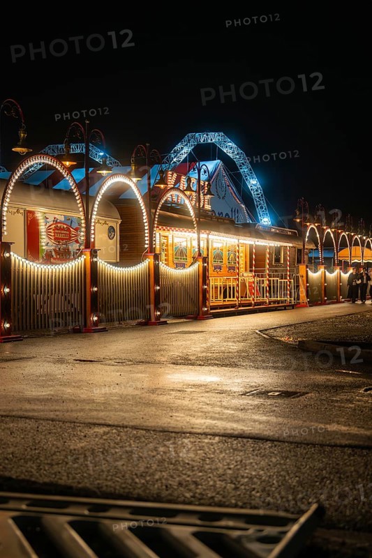 Atmospherically illuminated circus with arches and lamps at night, Böblingen, Germany