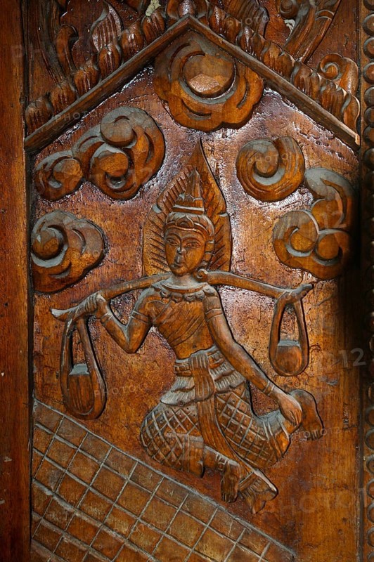 Temple door decorated with wood carvings in Buddhist monastery complex Buddhist temple complex Wat Sri Sunthon, Phuket Island, Thailand