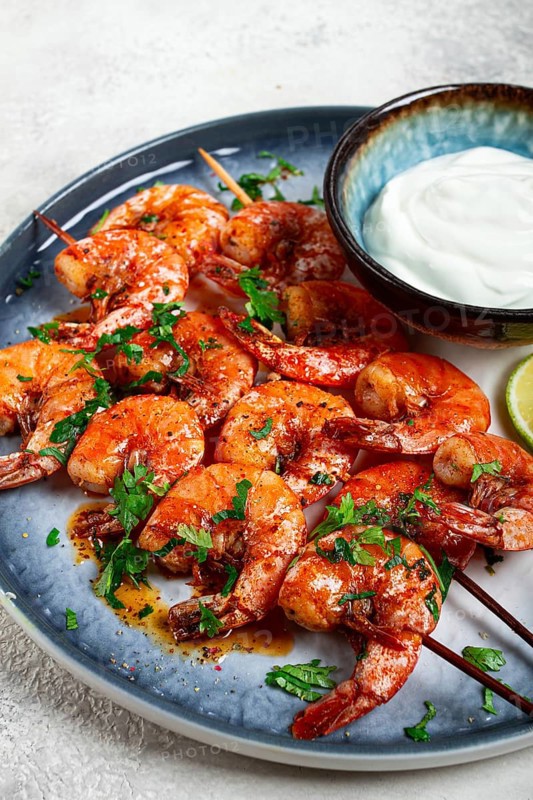 Fried shrimp, without a head, on skewers, shrimp kebabs, with spices, grilled, homemade, without people