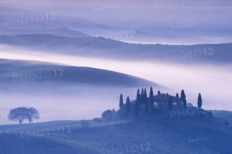 Landscape in Tuscany in the morning mist, Podere Belvedere winery in Val d'Orcia