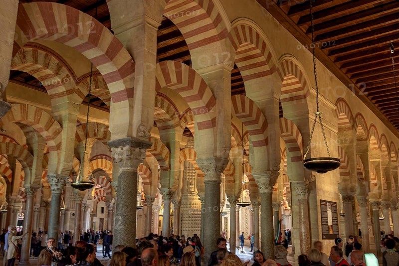 Architecture with striking arches and red and white stripes, interior filled with people, Cathedral Mosque of Córdoba (Mezquita-Catedral), Cordoba, Andalusia, Spain