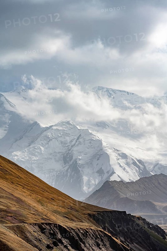 Dramatic mountain landscape, mountain valley, behind glaciated and snow-covered mountain peak Pik Lenin, Trans Alay Mountains, Pamir Mountains, Osh Province, Kyrgyzstan