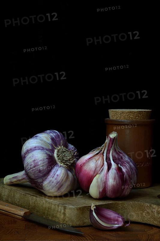 Fresh red garlic on chopping board, France