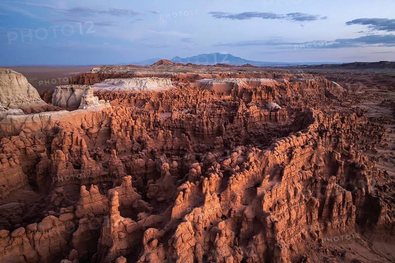 Aerial photograph capturing the breathtaking landscape of Goblin Valley State Park, Utah, showcasing its unique sandstone formations and captivating geological features under a vast sky