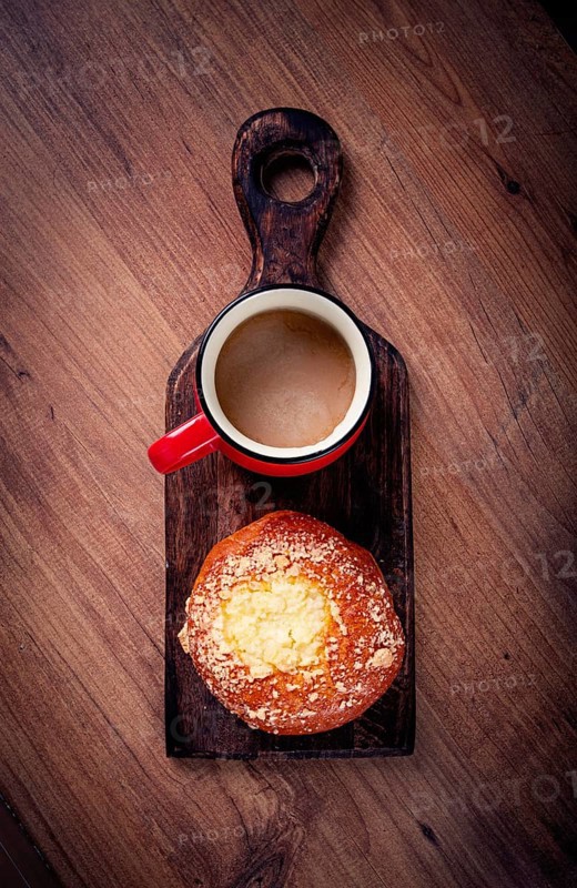Pastries, breakfast, a bun with cottage cheese and a cup of coffee, top view, no people