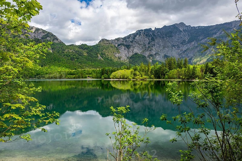 Landscape of Lake Offensee after rain when the sun comes through the clouds in spring, Salzkammergut, Austria