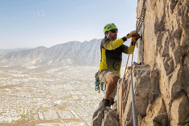 A man skillfully practices mountaineering and rappelling on the rugged cliffs of Eagleâ€™s Nest in Monterrey, Mexico, showcasing adventurous spirit and outdoor excitement