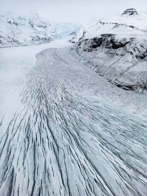 Aerial view of the stunning Icelandic winter landscape, showcasing remote, wild nature with snow-covered mountains and ice formations, highlighting the pristine cold beauty, Ã–rÃ¦fi, Austurland, Islandia