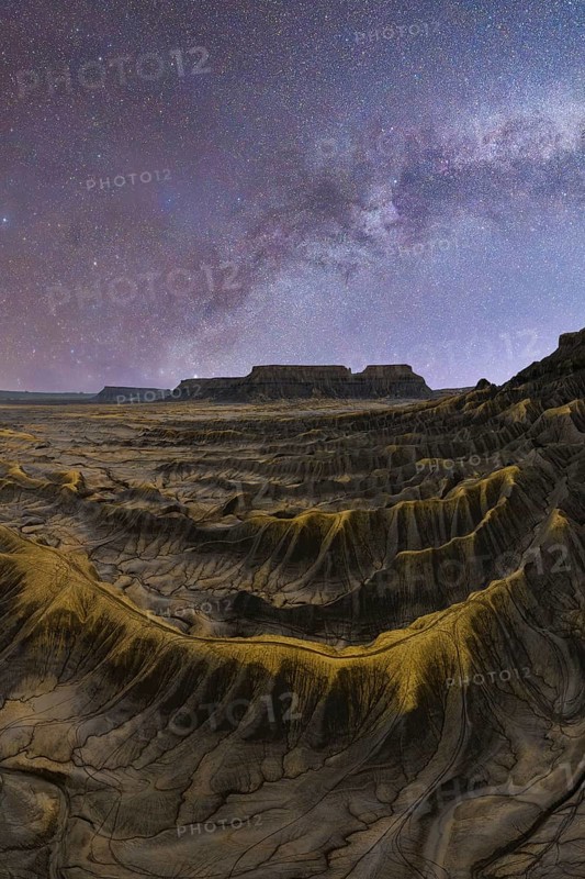 Stunning capture of the Milky Way illuminating the textured sandstone desert landscape in Utah, United States, showcasing the vast beauty of the natural world