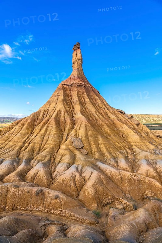 Majestic castildetierra rock formation rises against a vibrant blue sky in the bardenas reales desert, showcasing the power of erosion and the beauty of nature