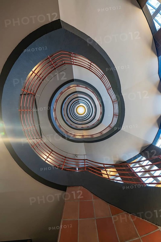 Dizzying view through a spiral staircase with red and black elements, SPRINKENHOF, Hamburg, Germany