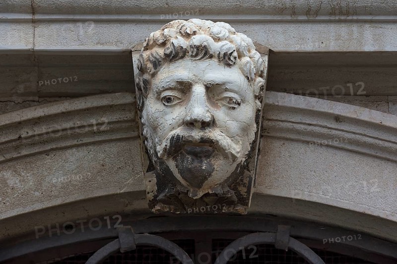 Sculpture of a head above a gate, Venice, Veneto, Italy