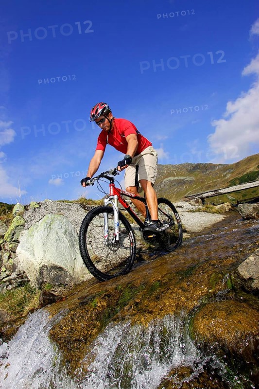 A man on a mountain bike in an alpine landscape