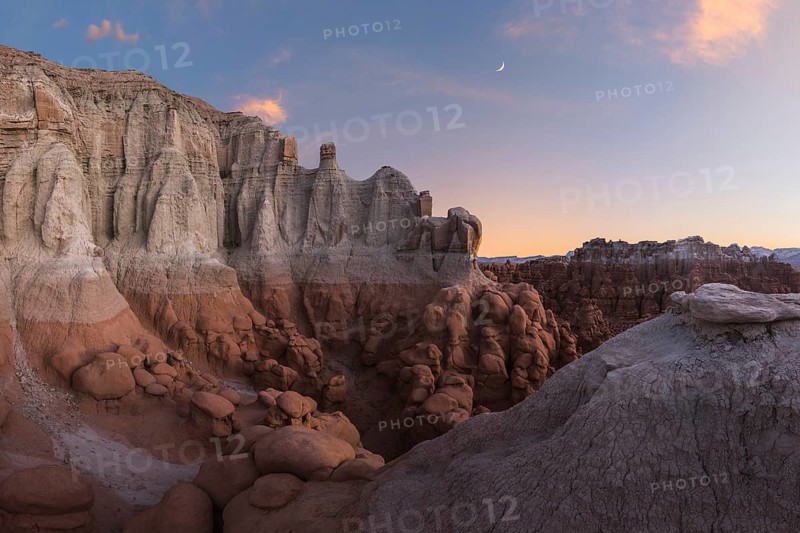 Scenic view of unique sandstone formations at Goblin Valley State Park in Utah during sunset, showcasing natural beauty and geological wonder in a serene setting