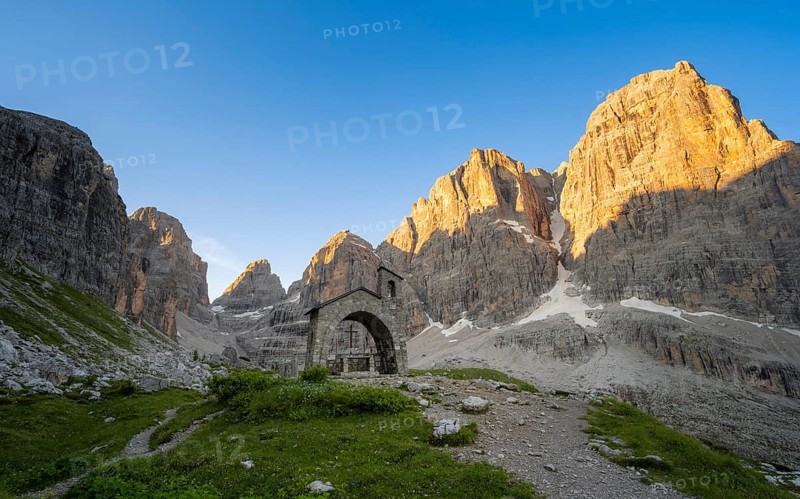 Cappella Ai Brentei chapel Memorial for injured mountaineers at the Rifugio Ai Brentei mountain hut, rocky peaks at sunrise with alpine glow, picturesque mountain landscape, Brenta, Trentino, Italy