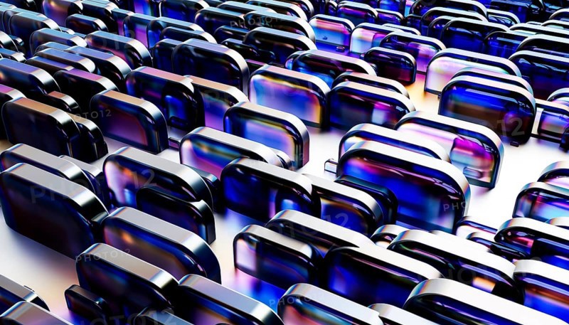 Dynamic abstract pattern featuring metallic and glass like rounded shapes. The shimmering reflections and vibrant blue hues create a futuristic and technological aesthetic