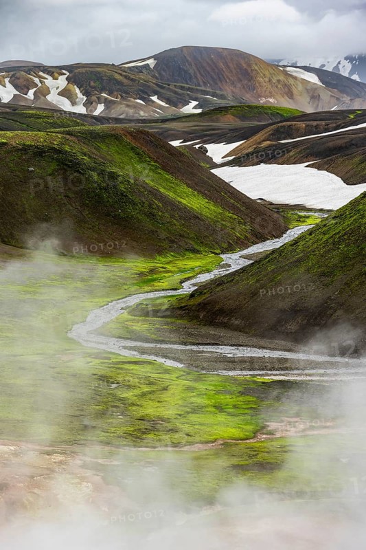 Colourful volcanic landscape with hills and snow, volcanic steaming hot springs, Laugavegur trekking trail, Landmannalaugar, Fjallabak Nature Reserve, Icelandic Highlands, Suðurland, Iceland