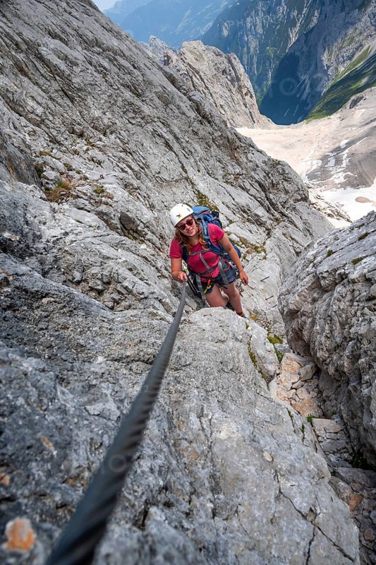 Mountaineer with helmet climbing in a secured via ferrata, Zugspitze via ferrata, ascent to the Zugspitze, Wetterstein range, Wetterstein range, Bavaria, Germany