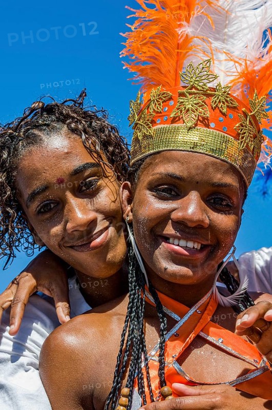 Colourful costumed, pretty, young woman with boyfriend. Carnival. Mindelo. Cabo Verde. Africa