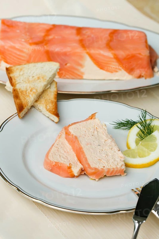 Southern German cuisine, salmon trout terrine arranged on a plate, salmon terrine with trout fillets, fish dish, salmon fillets, smoked salmon, starter, fine dining, Sunday crockery with gold rim, grandma's service, lemons, dill, fish cutlery, toast, food photography, studio, Germany