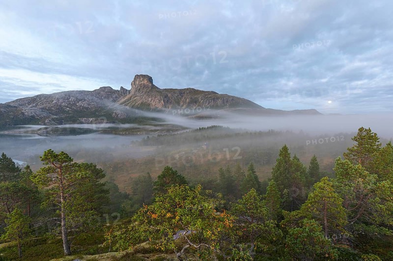 Magical morning fog on Steigtindvatnet in front of the majestic Steigtinden in Norway near Bodø