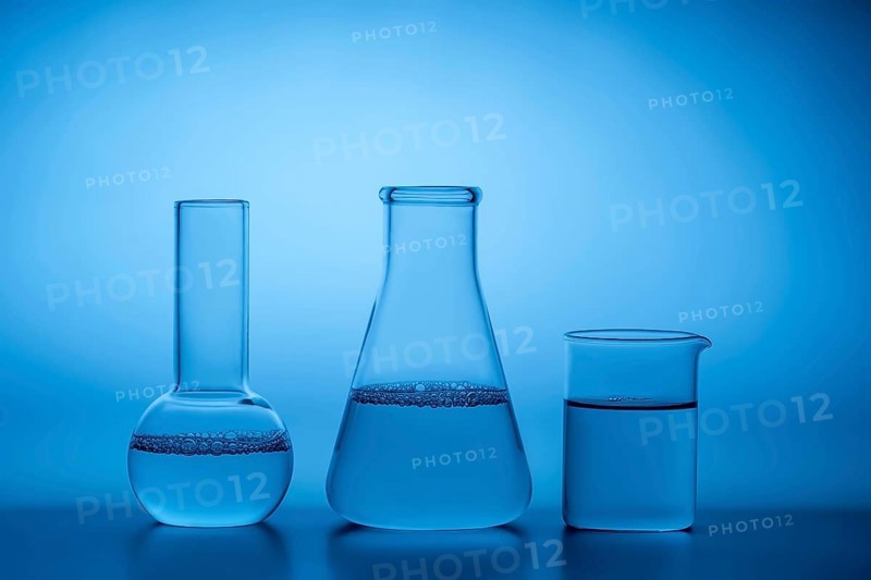 Glass laboratory beakers and flasks filled with water against a serene blue background, highlighting the clarity and precision associated with scientific research