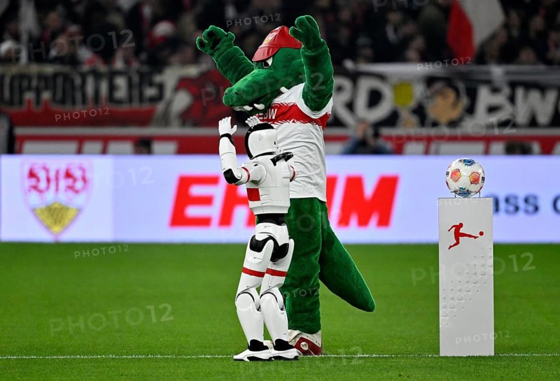 During the DFL and VfB Stuttgart Innovation Matchday, an AI-supported robot hands over the Adidas Derbystar game ball to the mascot Fritzle VfB Stuttgart logo soccer Bundesliga, MHPArena, MHP Arena Stuttgart, Baden-Württemberg, Germany