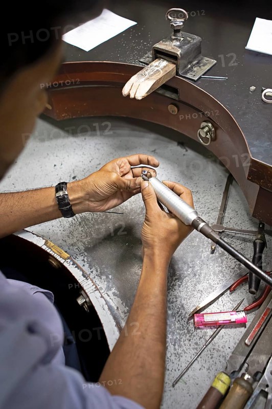 Gemstone cutter cutting a sapphire ring, gemstone cutting workshop in Kandy, Central Province, Sri Lanka