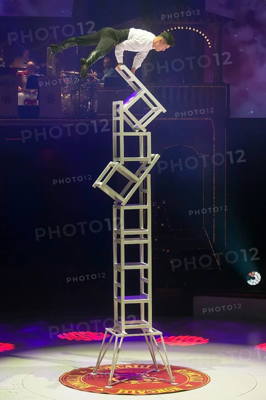 Artist on chairs at the Roncalli Christmas Circus in Berlin's Tempodrom on 20 December 2024