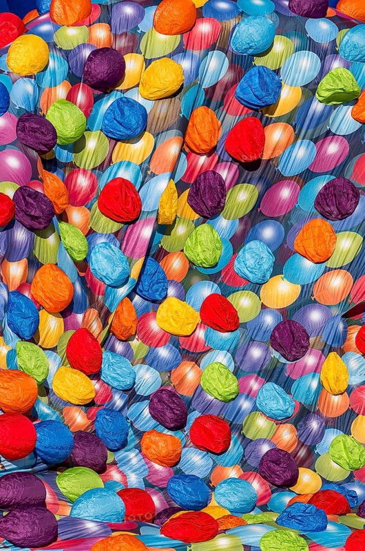 A bright and colorful image featuring a multitude of balloon patterns in a hot air balloons festival of castle of Oex, creating a festive and lively textured backdrop