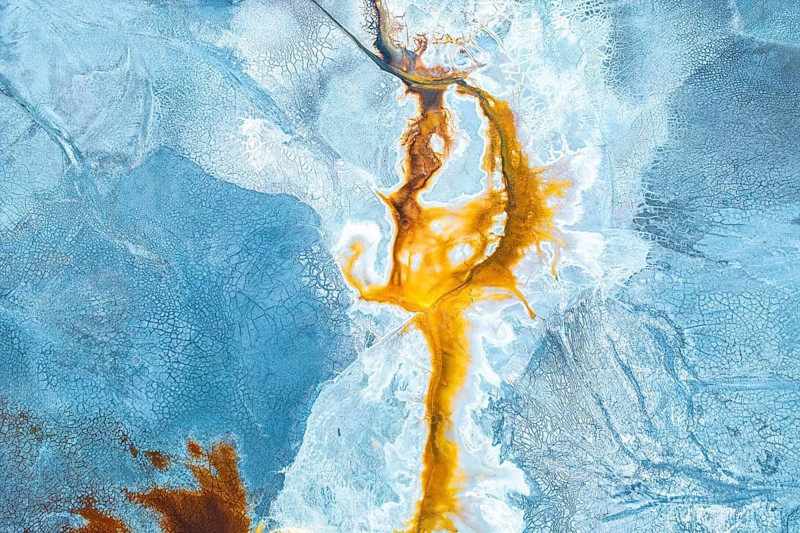 Aerial photo capturing a vibrant, abstract landscape where natural textures and colors mix dramatically