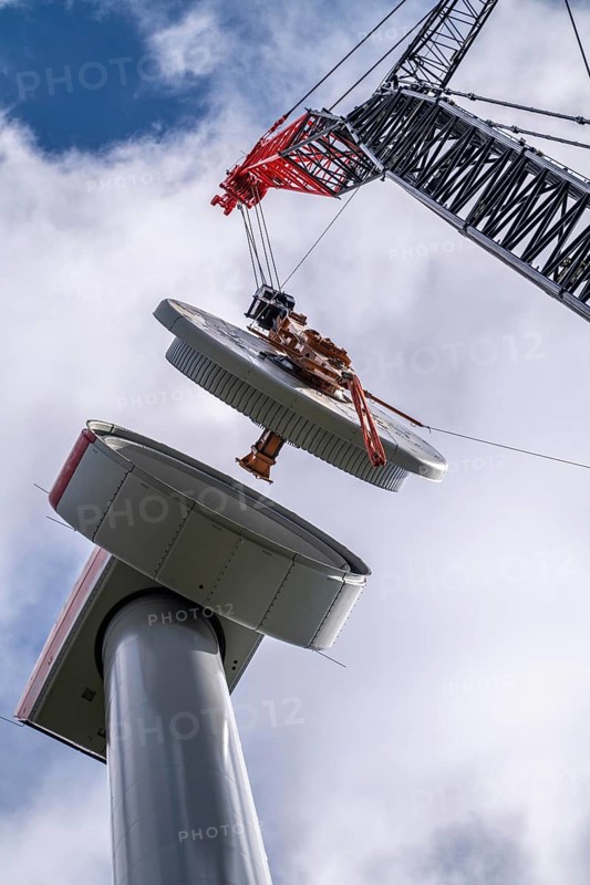 Erection of a wind turbine, wind energy plant, assembly of the ring generator, with a crawler lattice crane, wind farm near Hagen, North Rhine-Westphalia, Germany