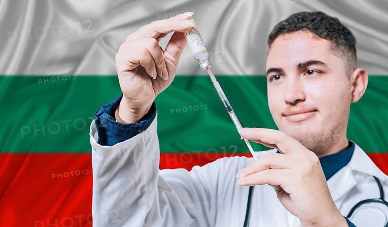 Doctor holding syringe on Bulgaria flag background. Medical professional holding syringe with Bulgarian flag in the background
