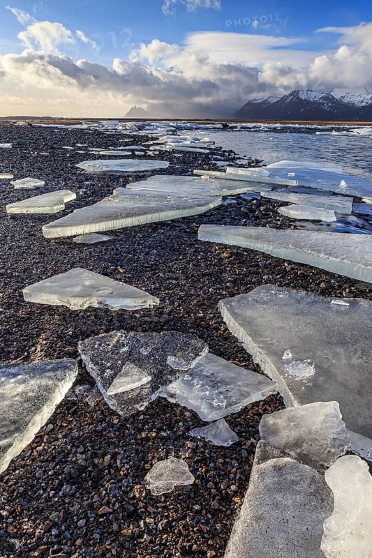 Ice floes on the beach, snowy, waves, sea, cloudy mood, winter, Lonsvik, Höfn, Iceland