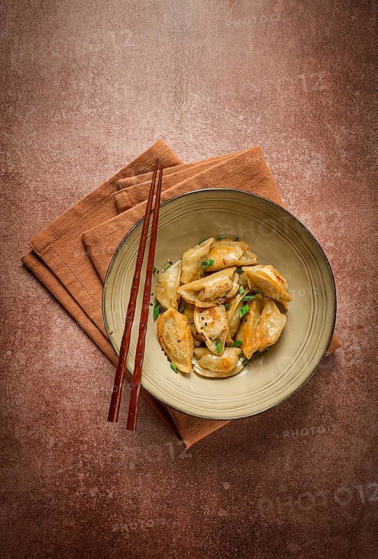 Japanese fried gyoza dumplings, with pork, sesame seeds, green onions