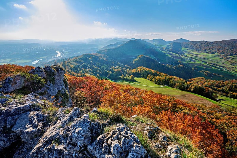 View of an autumnal forest from the Gisliflue, behind the Jura foothills with Wasserfluh and Strihen, Talheim, Canton, Aargau, Switzerland