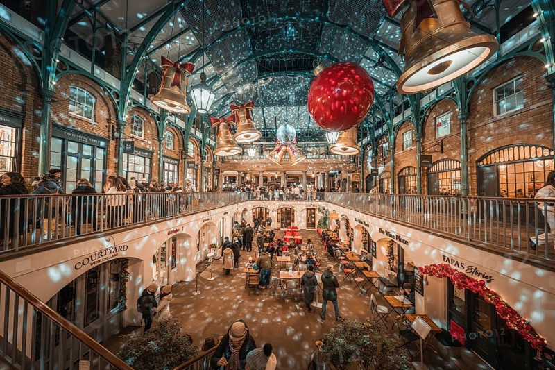 A festive interior with twinkling lights and two-level decoration full of people, AppleMarket, London, United Kingdom