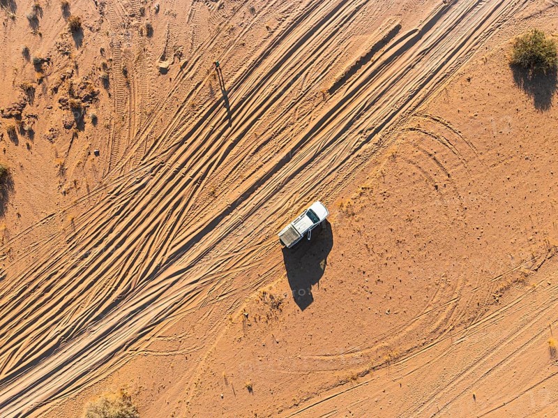 Aerial view, lonely road with offroad car, desert landscape, Erongo, Damaraland, Namibia