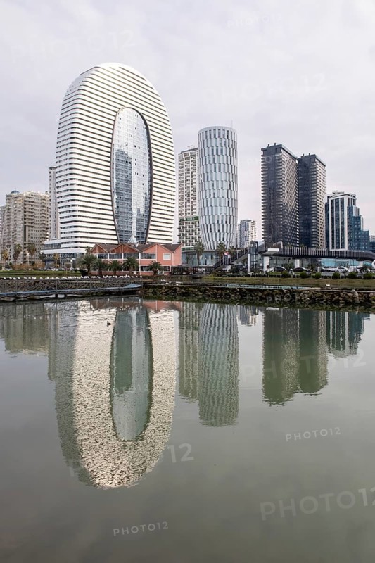 Stunning view of modern highrise architecture in Batumi, Georgia, with sleek buildings reflecting in the calm waters of a scenic cityscape. A beautiful blend of urban design