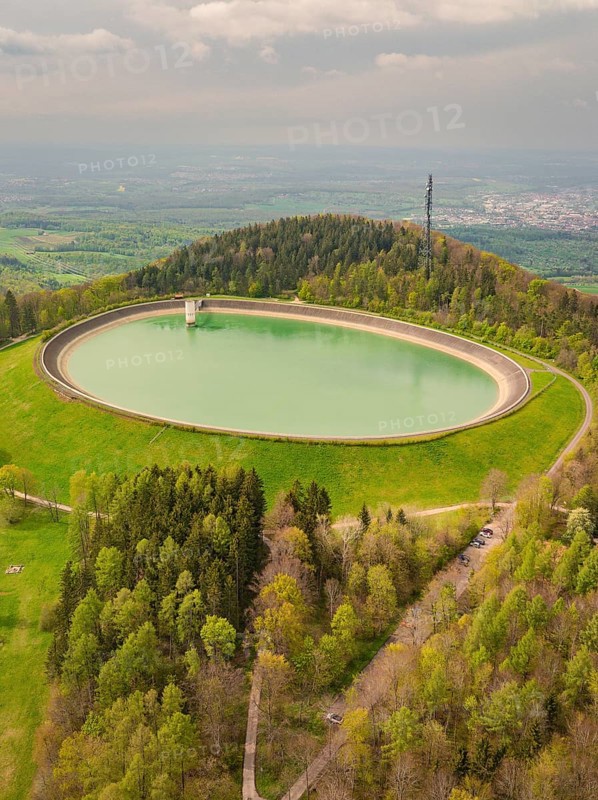 Upper reservoir, view of a water reservoir surrounded by green landscape and forest, Glems reservoir, Swabian Alb, Germany