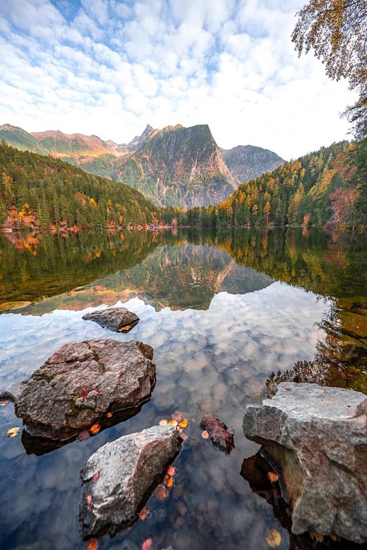 Mountain peaks of the Ötztal Alps reflected in Lake Piburger See, in autumn, near Ötz in Ötztal, Tyrol, Austria