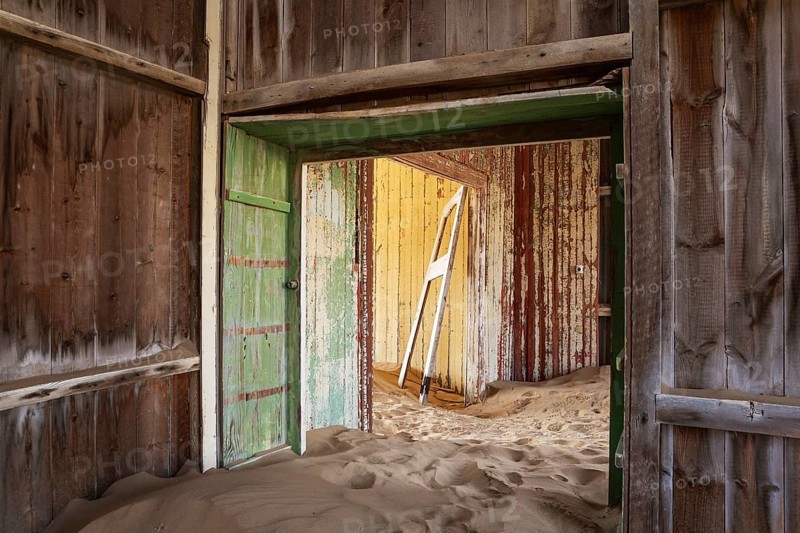 At Kolmanskop, the abandoned ghost town of the diamond days of the early 1900 and of German origin. Inside the restricted Diamond Area east of the coastal town of Lüderitz. Namib Desert, Namibia