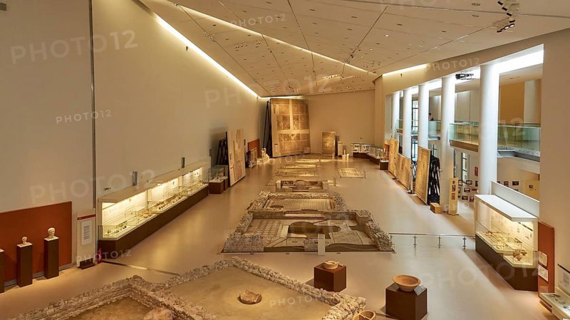 Long room in the museum with archaeological artifacts and well-lit display cases, Patras Archaeological Museum, Patras, Peloponnese, Greece