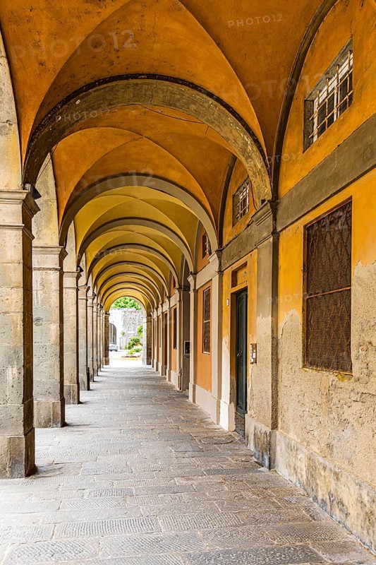 Arched arcades in Via Elisa, historic city centre, Lucca, Tuscany, Italy