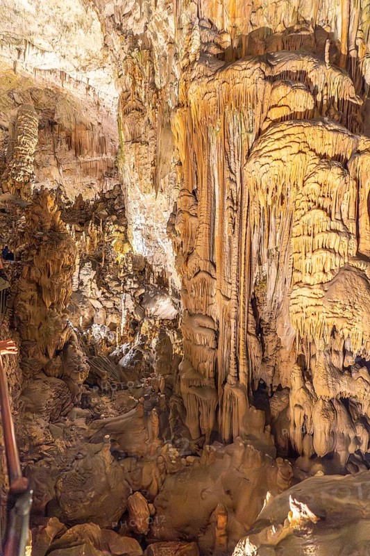 Tourists marvel at the stunning stalactites and stalagmites formations inside postojna cave, a popular destination in slovenia