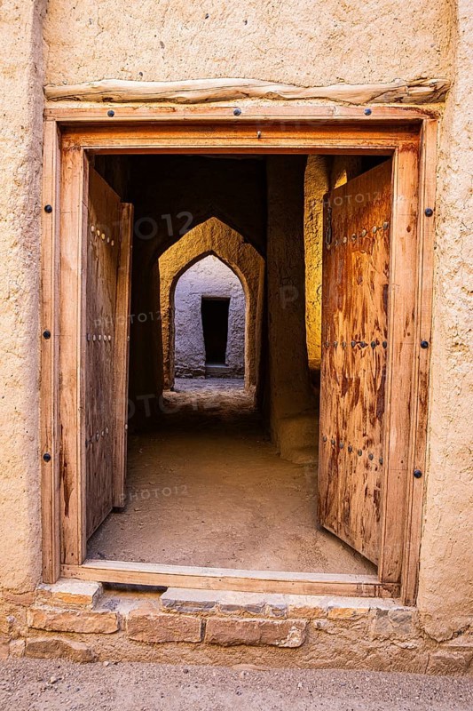 View through an entrance door in the largest preserved mud town in Oman, Al Bilaad, Al Bilaad Historical Village, Arabian Peninsula, Sultanate of Oman