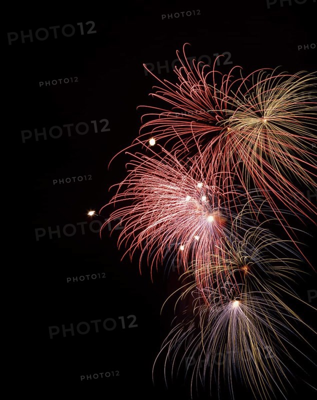Red, blue and yellow fireworks bursts in night sky, Montreal International Fireworks Festival, Quebec, Canada