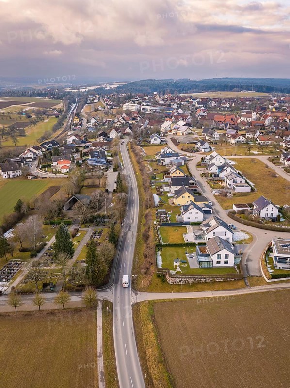 Aerial view of a rural suburb with streets and houses next to open fields, Schopfloch, Freudenstadt district, Germany