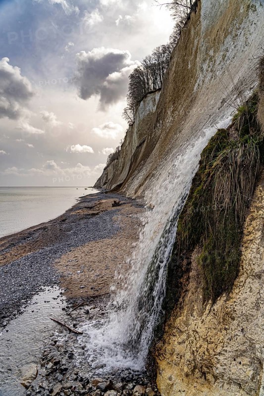 Waterfall of the Kiel stream on the Kiel shore and the famous chalk cliffs on the Baltic Sea coast in Jasmund National Park, Ruegen Island, Mecklenburg-Western Pomerania, Germany