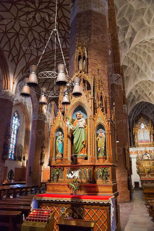 Gothic altar in a church with ornate figures of saints and candle lighting, St Jakobi Church, Olsztyn, Allenstein, Warmia-Masuria, Poland